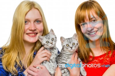 Two Girls Showing Young Silver Tabby Cats Stock Photo