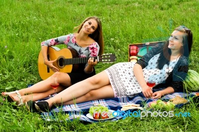 Two Girls With Guitar During Picnic Stock Photo