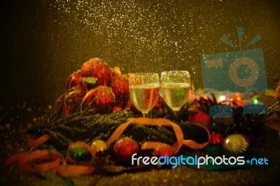 Two Glasses Of Champagne With A Christmas Decor In The Background Stock Photo