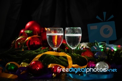 Two Glasses Of Champagne With A Christmas Decor In The Background Stock Photo