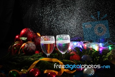 Two Glasses Of Champagne With A Christmas Decor In The Background Stock Photo