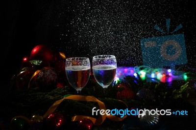 Two Glasses Of Champagne With A Christmas Decor In The Background Stock Photo