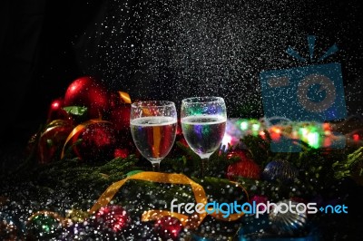 Two Glasses Of Champagne With A Christmas Decor In The Background Stock Photo