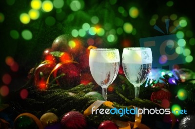 Two Glasses Of Champagne With A Christmas Decor In The Background Stock Photo