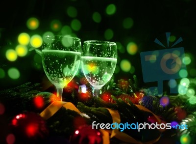 Two Glasses Of Champagne With A Christmas Decoration In The Background Stock Photo