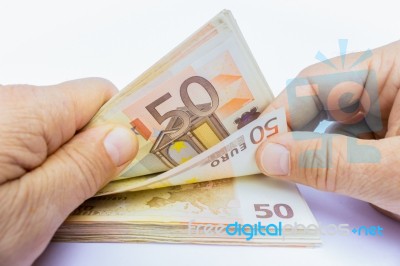 Two Hands Counting Euro Notes Stock Photo