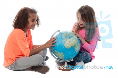 Two Little Girls Exploring A Globe Stock Photo