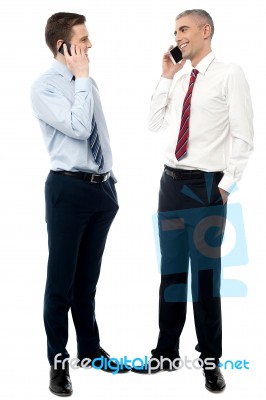 Two Male Entrepreneur Talking On Mobile Stock Photo