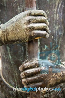 Two Metal Hands Gripping A Metal Rod Tightly Stock Photo