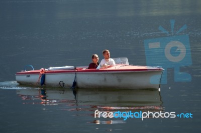 Two People In A Speedboat On Lake Hallstatt Stock Photo