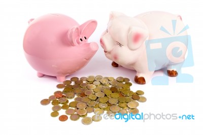 Two Piggy Banks With Euro Coins On White Stock Photo