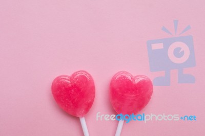 Two Pink Valentine's Day Heart Shape Lollipop Candy On Empty Pastel Pink Paper Background. Love Concept. Top View. Minimalism Colorful Hipster Style Stock Photo