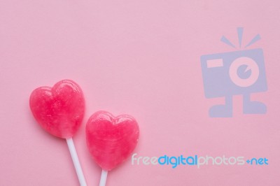 Two Pink Valentine's Day Heart Shape Lollipop Candy On Empty Pastel Pink Paper Background. Love Concept. Top View. Minimalism Colorful Hipster Style Stock Photo