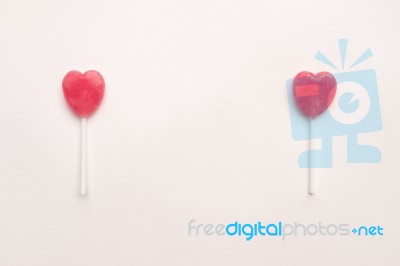 Two Pink Valentine's Day Heart Shape Lollipop Candy On Empty White Paper Background. Love Concept. Knolling Top View. Minimalism Colorful Hipster Style Stock Photo