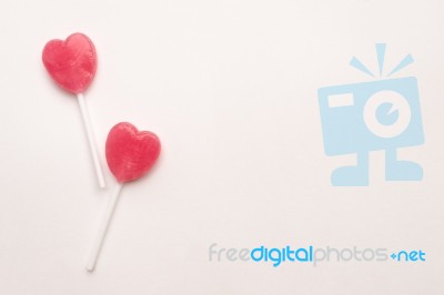 Two Pink Valentine's Day Heart Shape Lollipop Candy On Empty White Paper Background. Love Concept. Knolling Top View. Minimalism Colorful Hipster Style Stock Photo