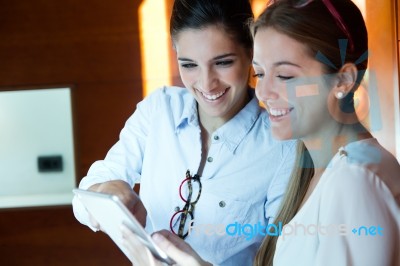 Two Pretty Business Women Working In The Office Stock Photo