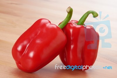 Two Red Sweet Peppers On The Table Stock Photo