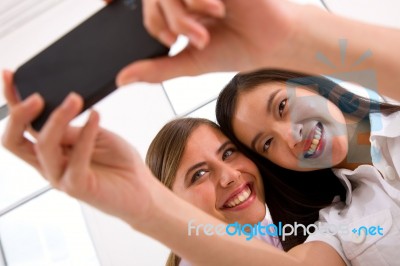 Two Smiling Young Women Taking Self Portrait Stock Photo