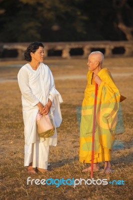 Two Unidentified Buddhist Female Monks Dressed In Orange And Whi… Stock Photo