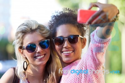 Two University Girl Students Taking A Selfie In The Street Stock Photo