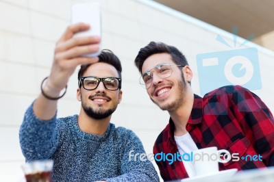 Two Young Entrepreneurs Taking A Selfie At Coffee Shop Stock Photo