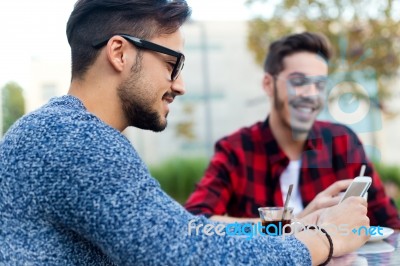 Two Young Entrepreneurs Working At Coffee Shop Stock Photo