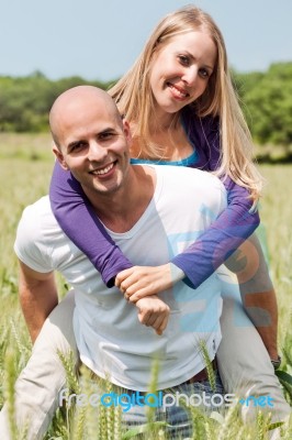 Two Young Lovers Holding Each Other Piggyback Stock Photo