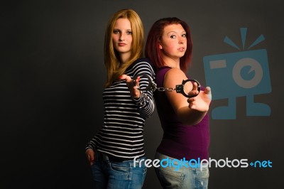 Two Young Women With Handcuffs Stock Photo