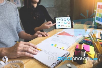 Two Young Women Working As Fashion Designers And Drawing Sketche… Stock Photo