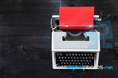 Typewriter And A Red Paper  On Wooden Background Retro Stock Photo