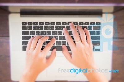 Typing On Keyboard Laptop Top View Of Wooden Table Stock Photo