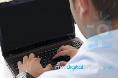 Typing On The Laptop In The Office Stock Photo