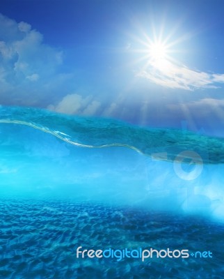 Under Clear Sea Water With Sun Shining Sky And Sand Dune Ground Stock Photo