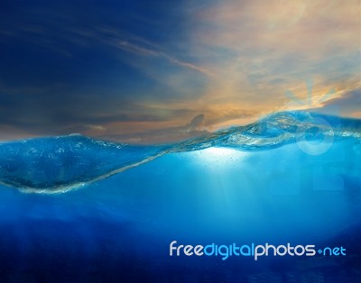 Under Clear Water With Beautiful Dramatic Sky Above Stock Photo