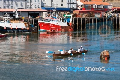 Unidentified Man And Boys Exhausted At The End Of A Rowing Boat Stock Photo