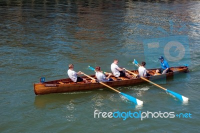 Unidentified Man And Boys Exhausted At The End Of A Rowing Boat Stock Photo