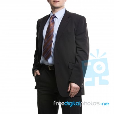 Unrecognizable Businessman In Suit Standing With Hand In Pocket Stock Photo