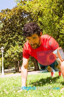 Urban Athlete Doing Push-ups Exercises On The Grass Stock Photo