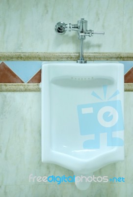 Urinal In A Men's Restroom Stock Photo