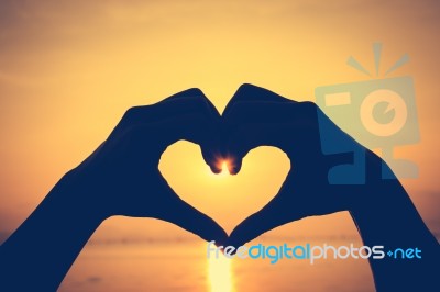 Valentine Background. Love Shape Hand Silhouette On Sky Backgrou… Stock Photo