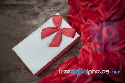 Valentine Gift Box On Wood Table With Red Roses Bouquet For Love And Happiness Theme Stock Photo