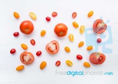 Variety Tomatoes On White Wooden Background Stock Photo