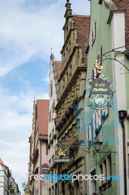 Various Hanging Signs In Rothenburg Stock Photo