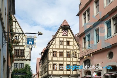 Various Hanging Signs In Rothenburg Stock Photo