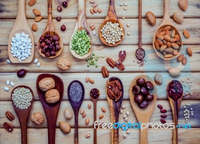 Various Legumes And Different Kinds Of Nutshells In Spoons. Waln… Stock Photo