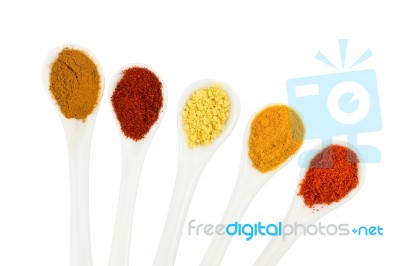 Various Seasoning Spices On Metal Spoons Stock Photo