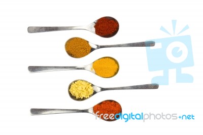 Various Seasoning Spices On Metal Spoons Stock Photo