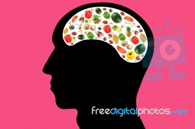 Vegetables And Fruits In Head On Pink Background Stock Photo