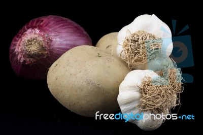 Vegetables. Potatoes, Garlics And Onion Stock Photo