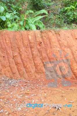 Vertical Red Cliff Of Small Level Ground Dig A Well Stock Photo